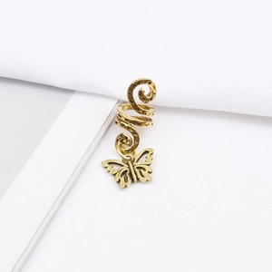 Detail of antique gold spiral hair coil with a hollow butterfly pendant for braids