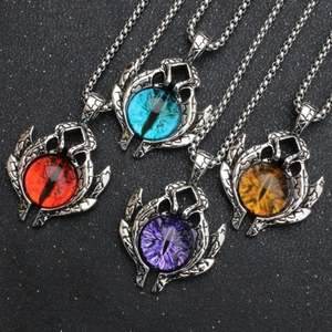 Detail of four retro punk evil eye pendants in red, blue, purple, and amber yellow