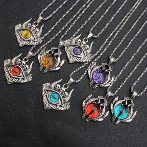 Detailed macro shot of gothic demon eye pendants with colorful resin pupils and skulls