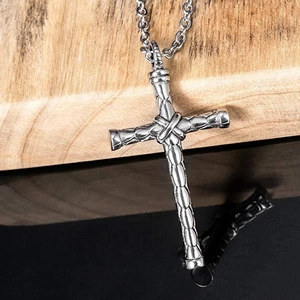 Industrial style silver cross pendant necklace with textured metallic finish and curb chain