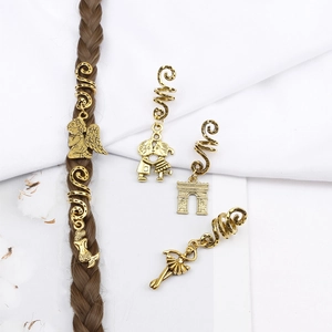 Detailed view of spiral hair rings with vintage gold alloy charms for dreadlock styling