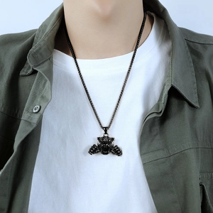 Détail d'un pendentif tête de bête noire et chaîne blé sur un collier en acier inoxydable