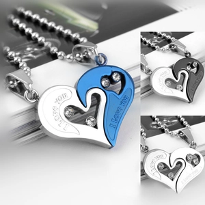Macro shot of interlocking heart pendants with rhinestone inlay and engraved I love you text