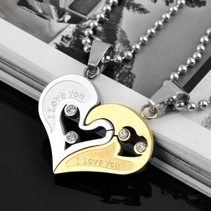 Detail of couple's heart necklaces in gold and silver with I Love You engraving