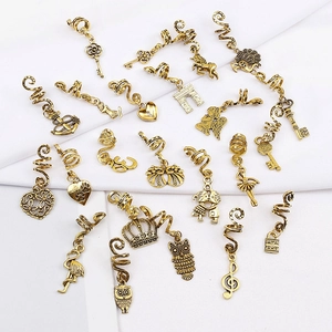Ancient gold alloy dreadlock hair rings with butterfly and mixed charms on white fabric