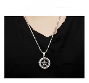 Macro detail of silver tire gear pendant with star design on titanium steel chain