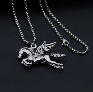 Macro detail of vintage silver Pegasus pendant with intricate wing texture on box chain