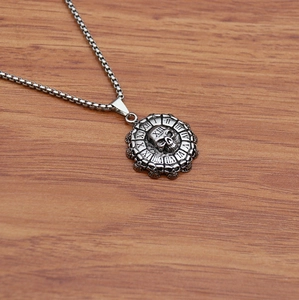 Detailed macro view of vintage skull pendant necklace with roman numerals clock on wood