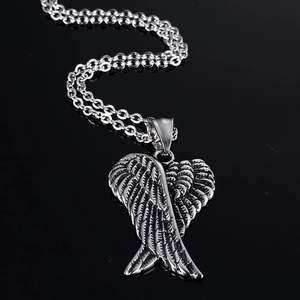 Silver angel wing heart pendant necklace with gothic punk metal chain on black reflection