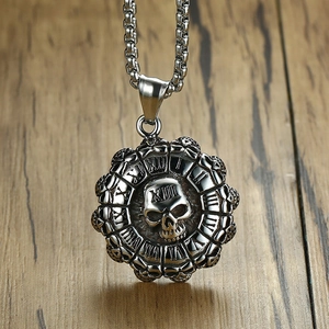 Macro detail of gothic skull pendant with Roman numerals on vintage stainless steel chain