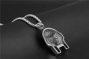 Close-up of the S-STEEL engraved back of a silver Egyptian Pharaoh pendant on leather