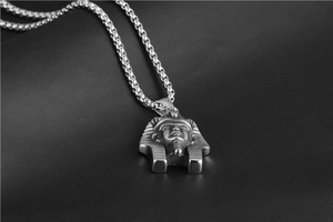 Macro shot of polished stainless steel Egyptian Pharaoh Tutankhamun pendant on box chain