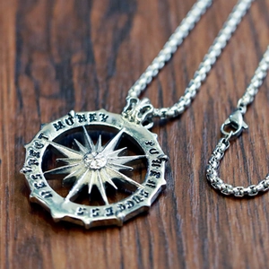 Detailed macro view of retro silver sun pendant with Money and Success engravings