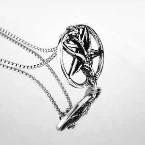 Detailed view of vintage silver Baphomet pentagram pendant with box chain on mirror