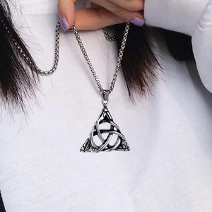 Silver Triquetra Celtic knot pendant necklace on square link chain worn on white sweater