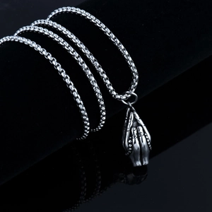 Detailed close-up of retro stainless steel prayer hands pendant on a sturdy box chain