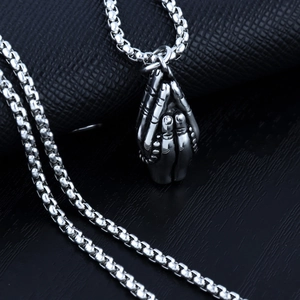 Detailed close-up of vintage stainless steel praying hands pendant on a sturdy box chain