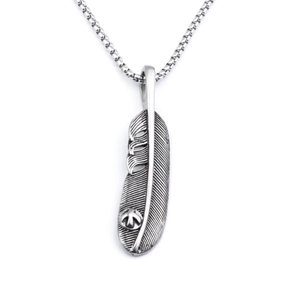 Detailed macro view of vintage feather pendant necklace with oxidized silver finish