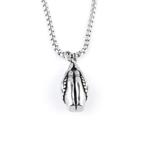 Macro shot of vintage stainless steel praying hands pendant on a silver box chain necklace