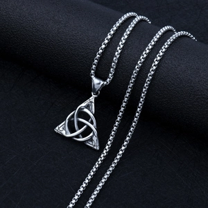 Detail of silver Celtic Triquetra knot pendant with durable steel box chain texture