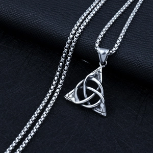Detailed close-up of a silver Celtic Triquetra knot pendant on a box chain for men