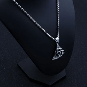 Detailed close-up of a silver Nordic Viking triangle pendant with Celtic knotwork