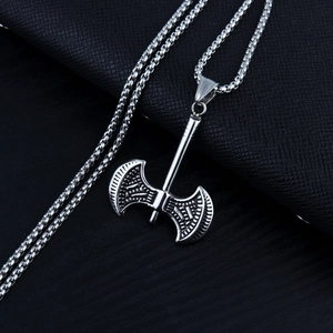 Detailed close-up of a silver titanium steel double-sided axe pendant on a box chain