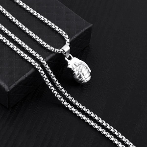 Polished silver grenade pendant necklace for men in punk style on black jewelry box