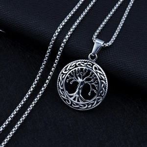 Detailed close-up of tree of life pendant with celtic knots on box chain necklace