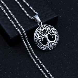 Detail view of Tree of Life pendant with Celtic patterns on a black jewelry box