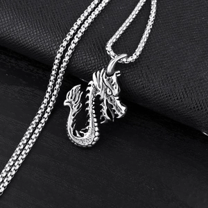 Vintage silver steel flame dragon pendant necklace with box chain for men on leather background