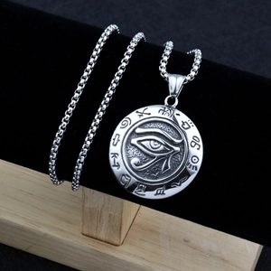 Close-up of retro Eye of Horus pendant with Egyptian hieroglyphs on a box chain
