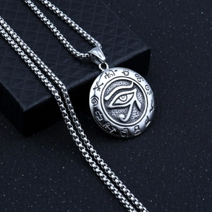 Macro shot of silver Eye of Horus pendant on box chain over black jewelry box