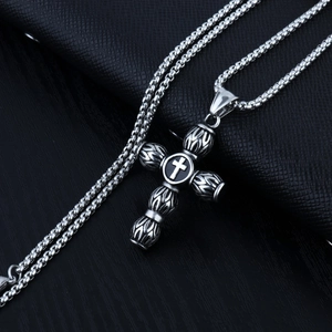 Retro stainless steel cross pendant necklace with box chain on black leather background