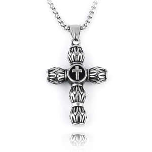 Detailed macro view of retro silver cross pendant with black center and leaf pattern relief