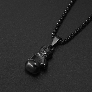 Detail of matte black boxing glove pendant necklace with heavy round pearl chain