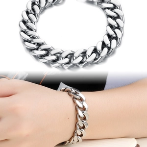 Detail of chunky stainless steel Cuban link bracelet with hidden clasp closure