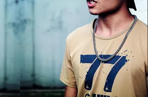 Hip-hop style silver stainless steel curb chain necklace worn on a street style t-shirt
