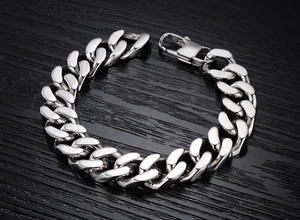 Close-up of industrial stainless steel Cuban link bracelet with secure lobster clasp