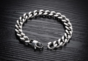 Macro detail of polished stainless steel Cuban link bracelet with large lobster clasp