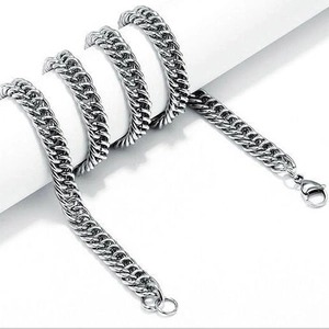 Polished titanium steel Cuban link chain necklace with lobster clasp on white pillar