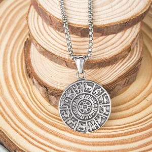 Gros plan détaillé d'un pendentif viking vintage avec runes sur tranches de bois