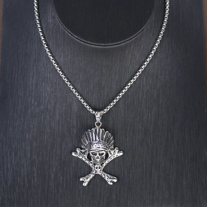 Detail of vintage silver Indian skull pendant with feathered headdress on square box chain