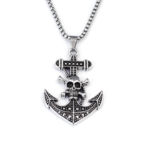 Detailed macro view of vintage silver anchor pendant with skull design and box chain necklace