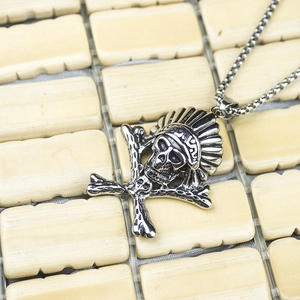 Detailed view of gothic punk skull pendant with Indian feather headdress and crossed bones