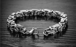 Detailed macro view of polished silver stainless steel Byzantine link bracelet for men