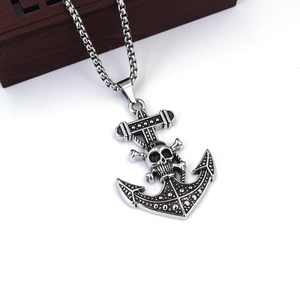 Detailed macro view of anchor pendant with skull motif and crossbones on box chain