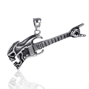 Macro shot of vintage skeleton hand pendant holding a guitar with rock music theme