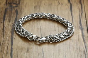Close-up of silver-tone stainless steel wheat link chain bracelet with lobster clasp