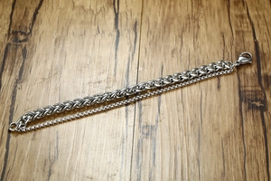 Detail of men's double-layer stainless steel bracelet with wheat and box chains